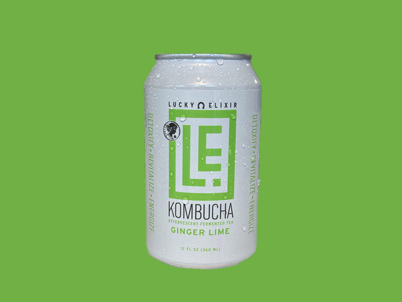 A can of Lucky Elixir Ginger Lime Kombucha with a green and white label on a green background.